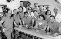 Group photo of surgeons posed in an operating room